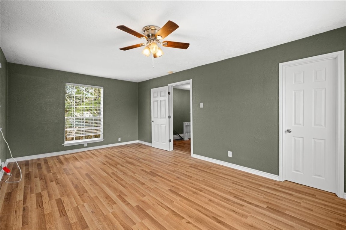 103 Emile Street Brenham, TX 77833 - Photo 12 of 22 a view of an empty room with window and wooden floor