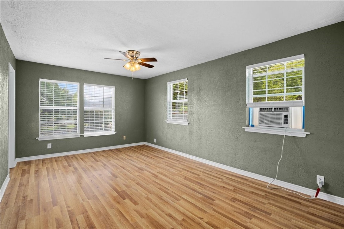 103 Emile Street Brenham, TX 77833 - Photo 13 of 22 a view of an empty room with a window and wooden floor