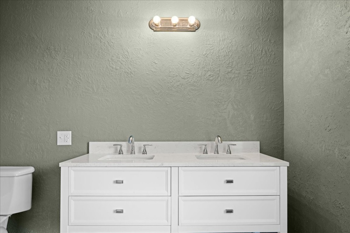 103 Emile Street Brenham, TX 77833 - Photo 15 of 22 a bathroom with a sink vanity and toilet