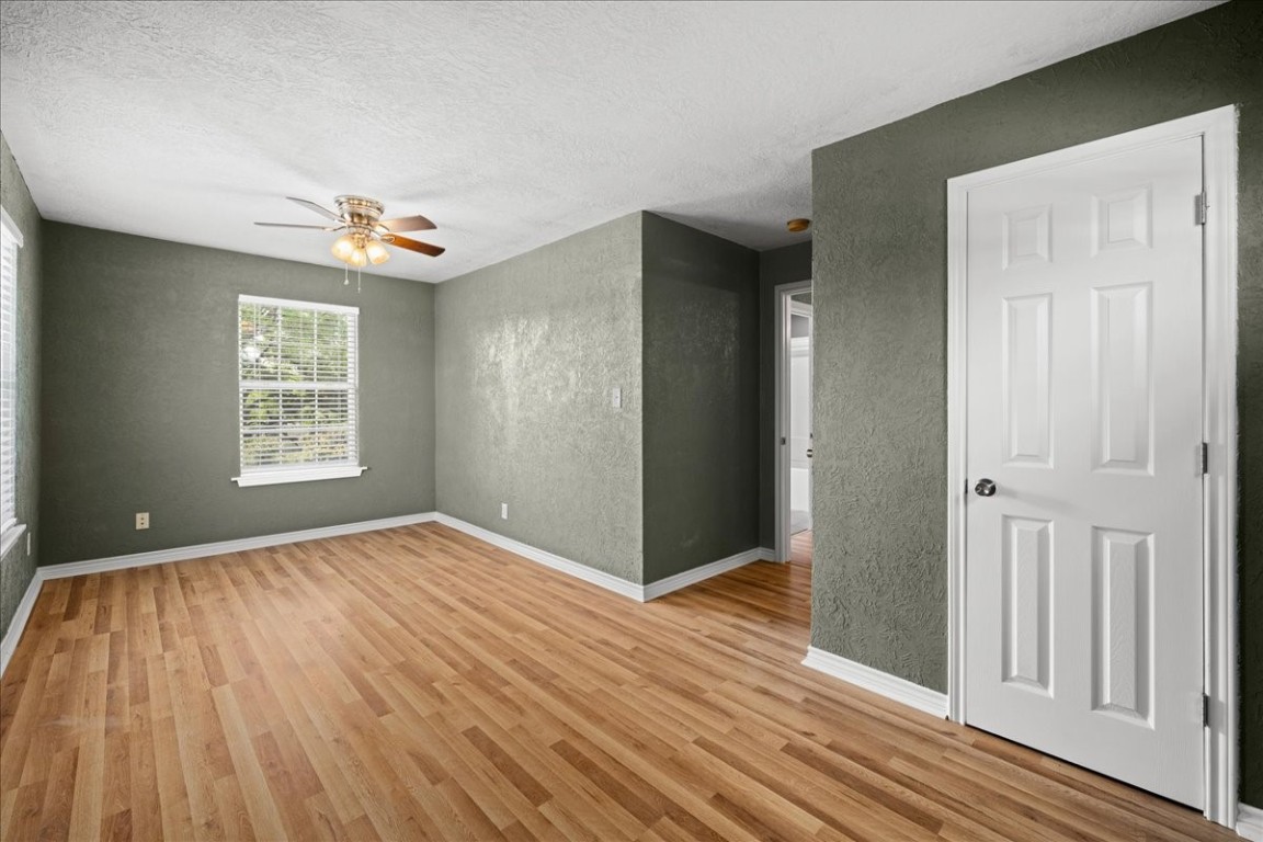 103 Emile Street Brenham, TX 77833 - Photo 16 of 22 wooden floor in an empty room with a window