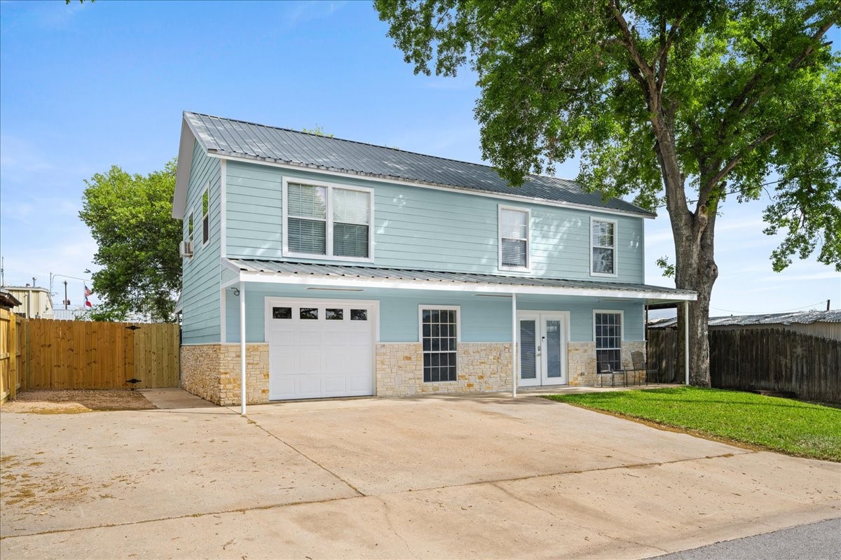 103 Emile Street Brenham, TX 77833 - Photo 2 of 22 front view of a house with a garden