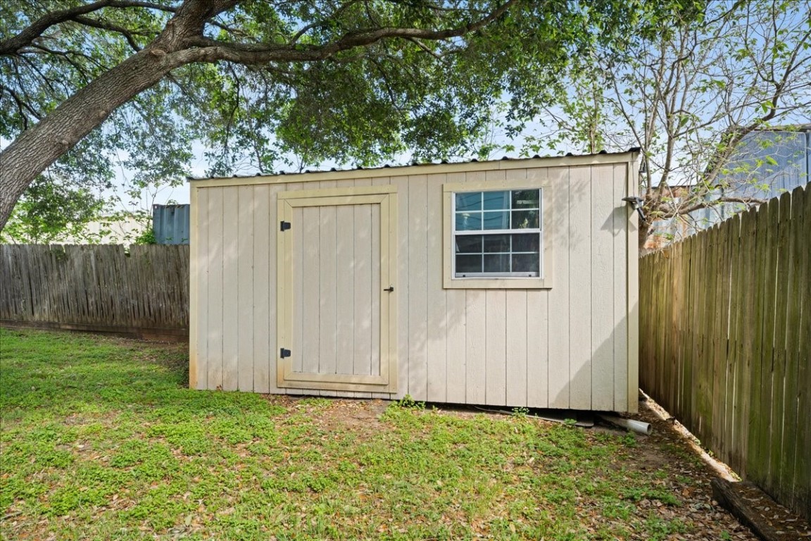 103 Emile Street Brenham, TX 77833 - Photo 22 of 22 a view of backyard with potted plants and a large tree