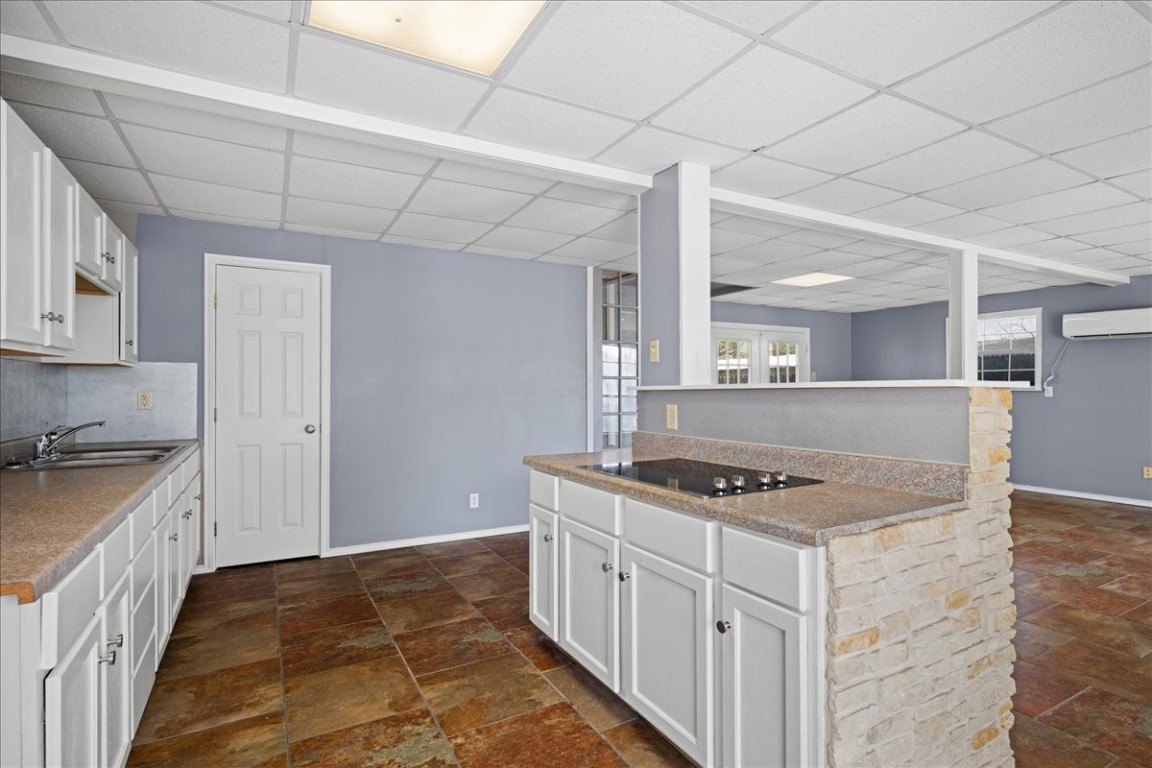 103 Emile Street Brenham, TX 77833 - Photo 7 of 22 a kitchen with stainless steel appliances granite countertop a stove a sink and a refrigerator