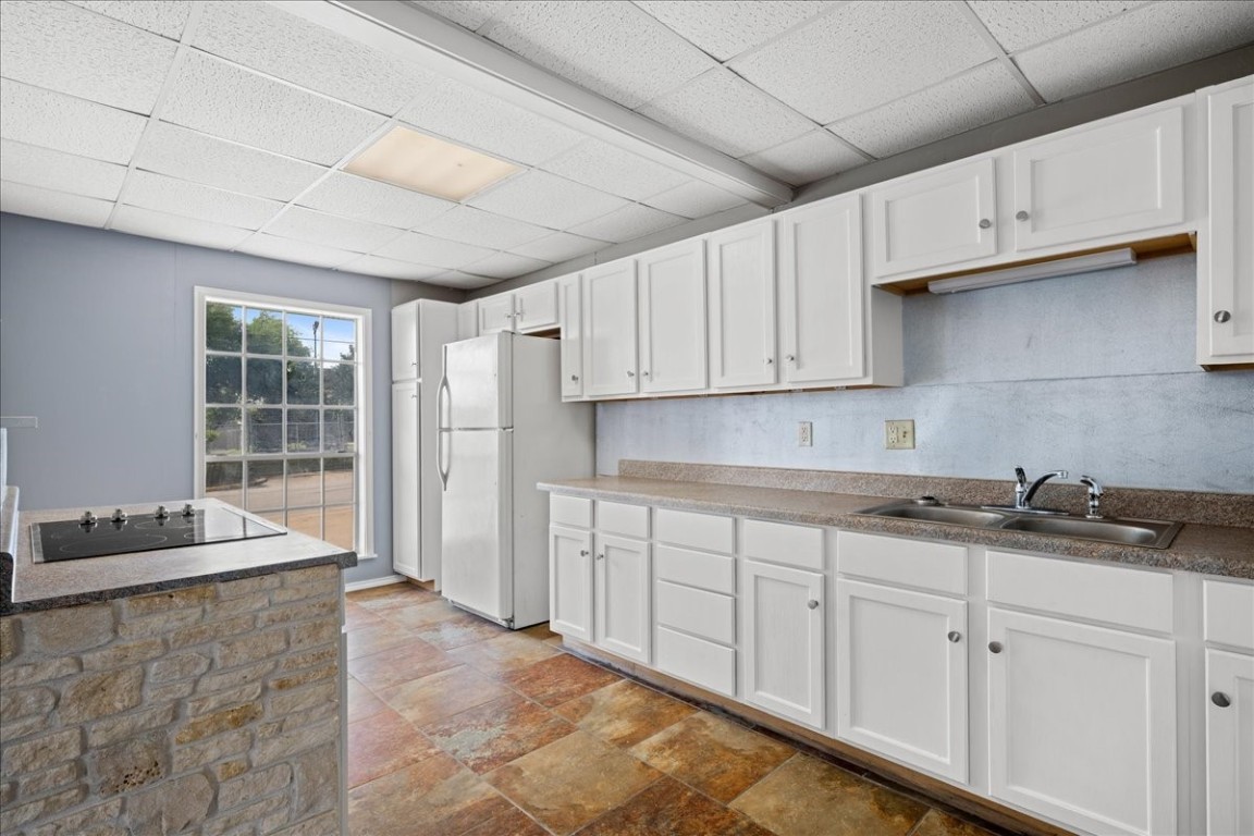 103 Emile Street Brenham, TX 77833 - Photo 8 of 22 a kitchen with stainless steel appliances granite countertop a sink stove and cabinets