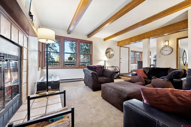 a living room with furniture and a floor to ceiling window