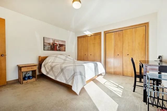 a bedroom with a bed and a large window