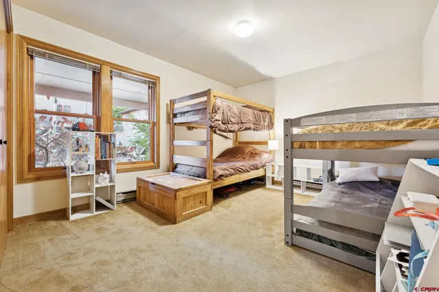 a bedroom with furniture and large window