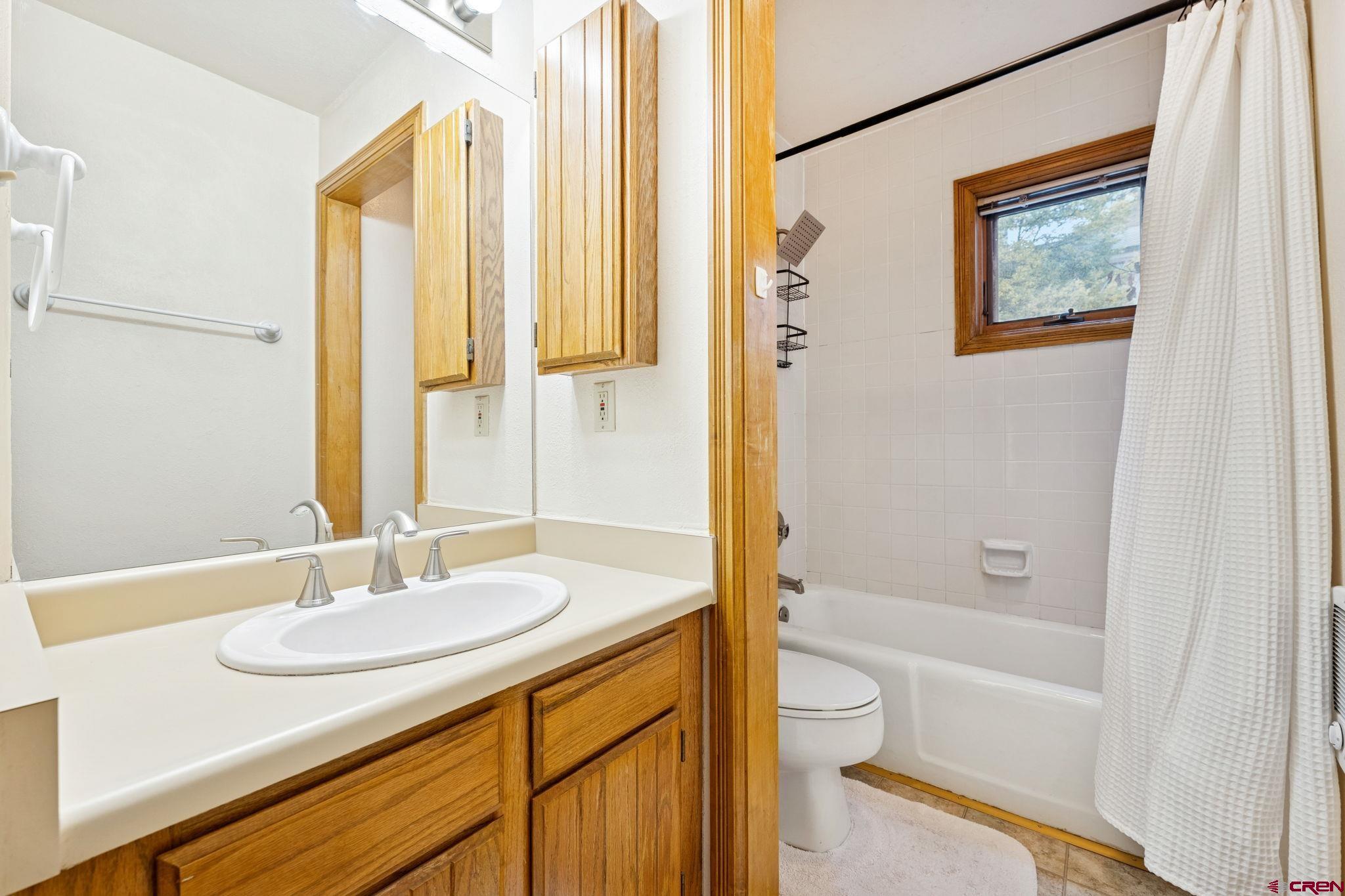 6 Ferringway Circle, Unit 18 Durango, CO 81301 - Photo 20 of 39 a bathroom with a granite countertop sink toilet and a bathtub
