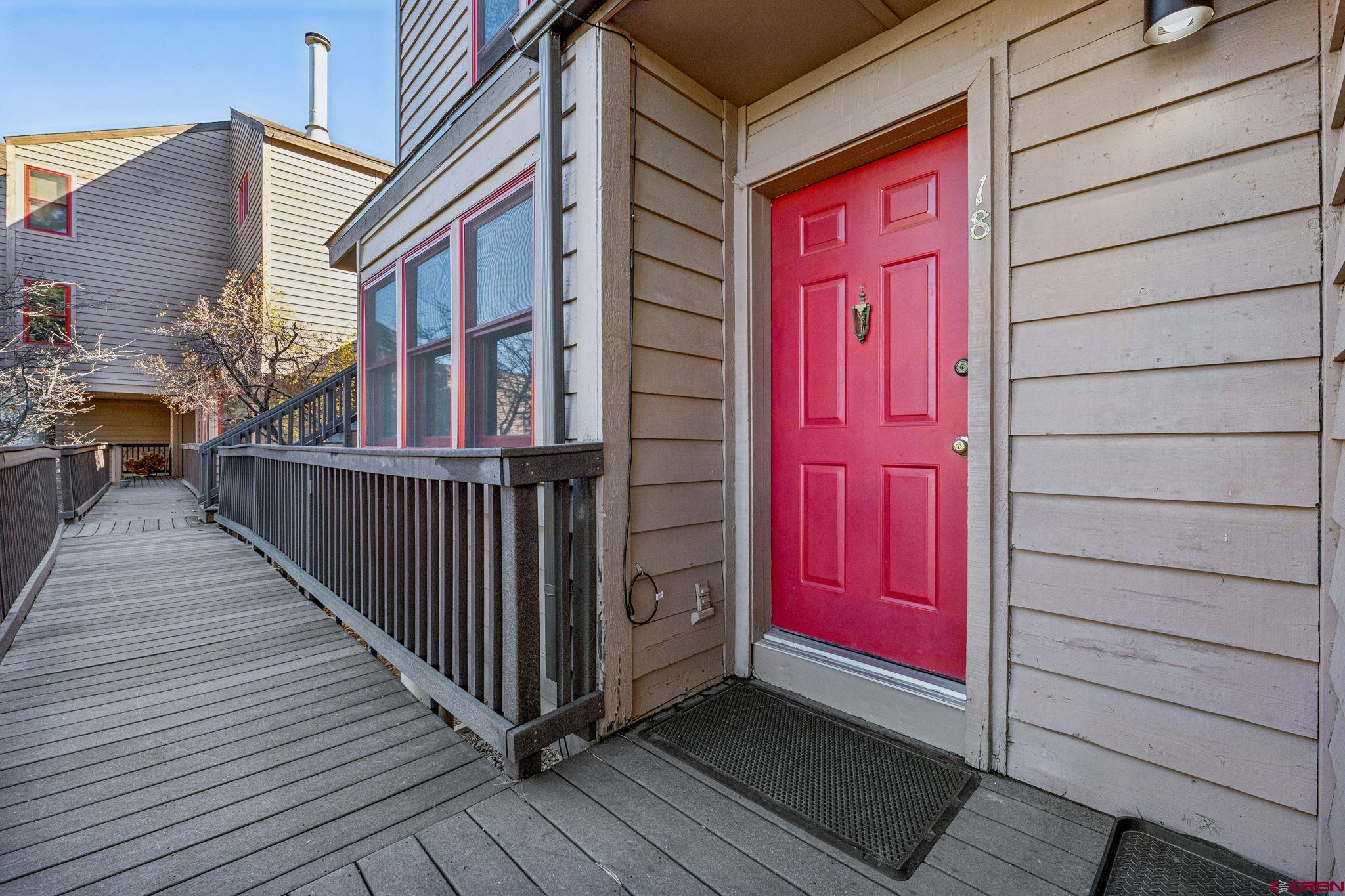 6 Ferringway Circle, Unit 18 Durango, CO 81301 - Photo 24 of 39 a view of a house with a red door and wooden floor