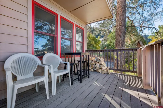 a view of a two chairs in the balcony