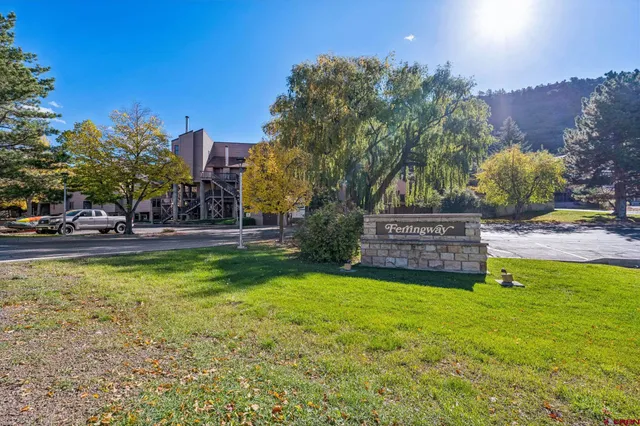 a view of a lush green hillside and houses