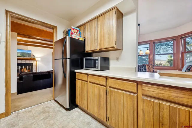 a kitchen with stainless steel appliances granite countertop a refrigerator and a sink
