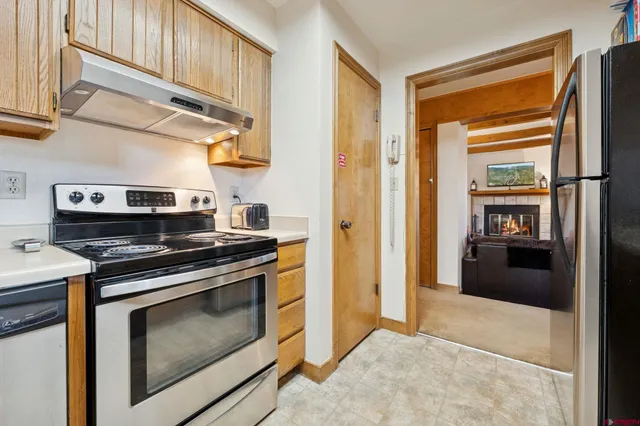a kitchen with stainless steel appliances granite countertop a stove and a refrigerator