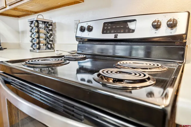 a stove top oven sitting inside of a kitchen