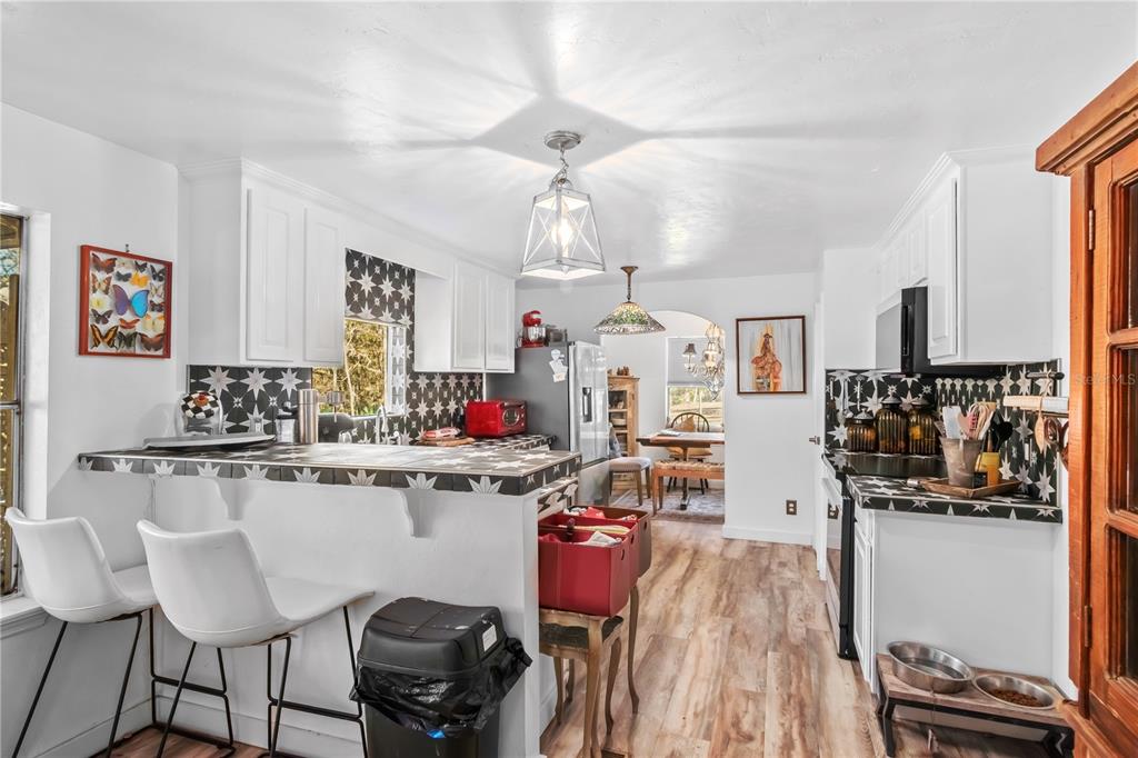 22924 Northwest 91st Court Road Micanopy, FL 32667 - Photo 16 of 95 a kitchen with a refrigerator and white cabinets