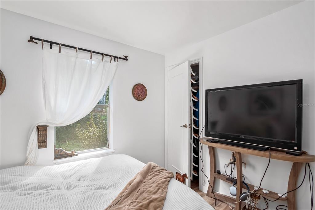 22924 Northwest 91st Court Road Micanopy, FL 32667 - Photo 24 of 95 a bedroom with a bed and a flat screen tv