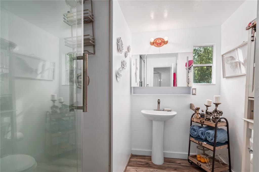 22924 Northwest 91st Court Road Micanopy, FL 32667 - Photo 25 of 95 a bathroom with a sink toilet and shower