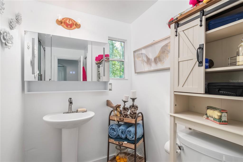 22924 Northwest 91st Court Road Micanopy, FL 32667 - Photo 26 of 95 a bathroom with a sink and a mirror