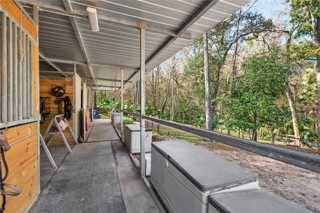 22924 Northwest 91st Court Road Micanopy, FL 32667 - Photo 64 of 95 a view of a patio with a table and chairs and wooden fence
