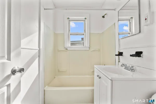 a bathroom with a bathtub and a sink