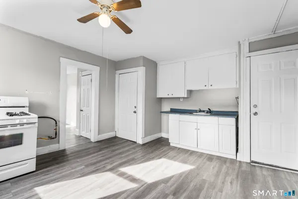 a kitchen with white cabinets and white appliances