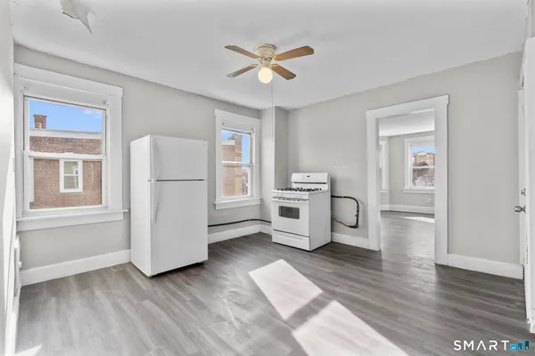 a view of kitchen with furniture and wooden floor