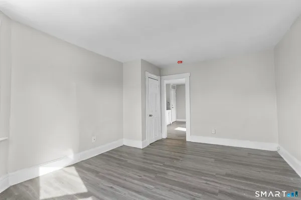 a view of an empty room and wooden floor
