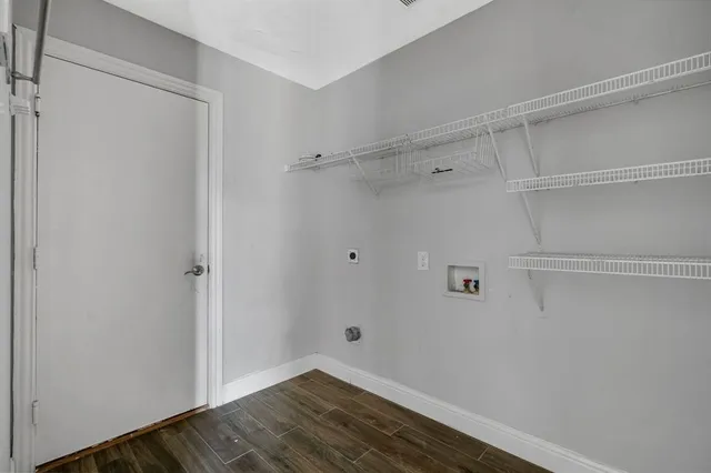 a view of a room with wooden floor