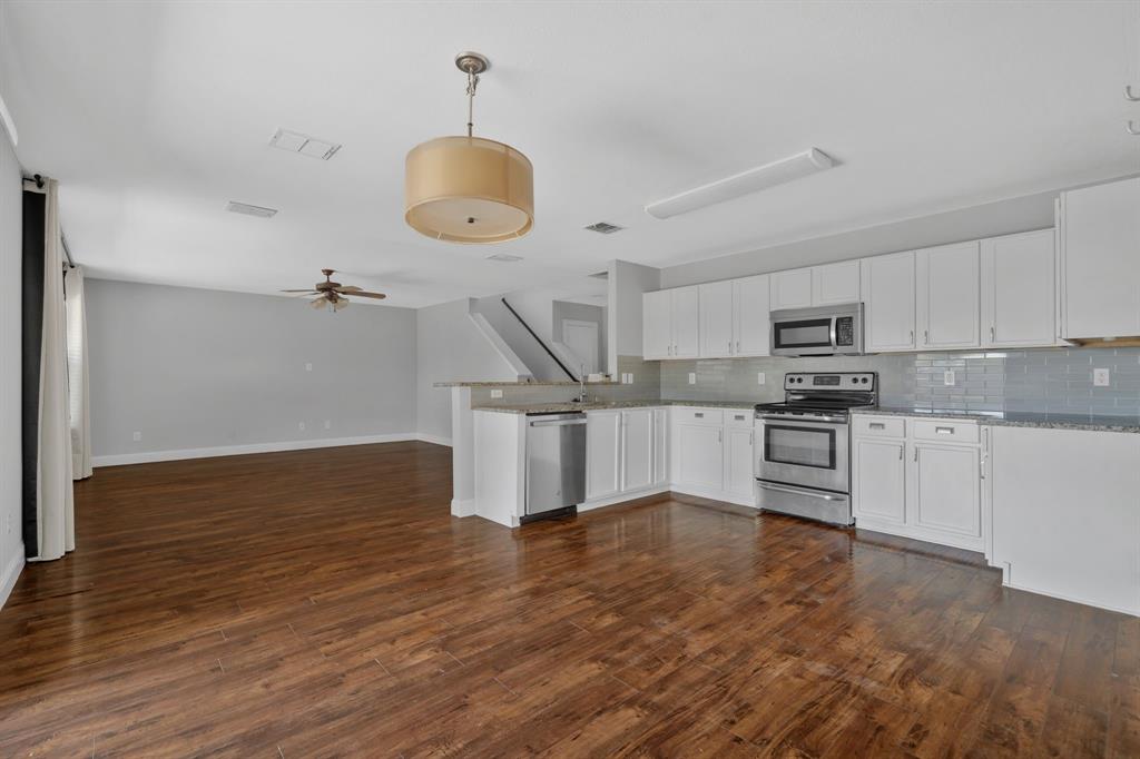 1725 Willow Way Anna, TX 75409 - Photo 16 of 33 a kitchen with granite countertop a stove and white cabinets