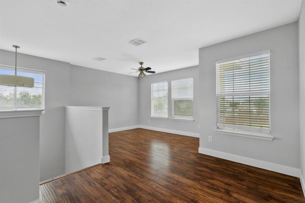 1725 Willow Way Anna, TX 75409 - Photo 19 of 33 a view of an empty room with wooden floor and a window