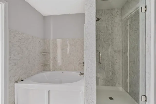 a bath tub sitting next to a shower