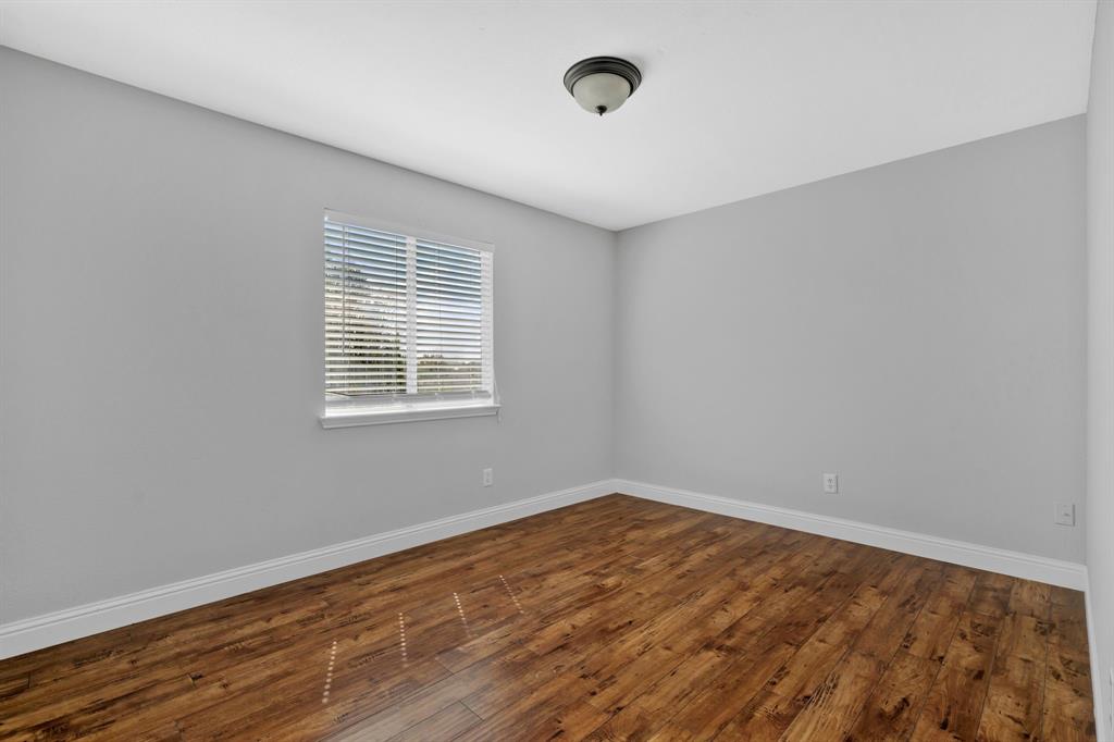 1725 Willow Way Anna, TX 75409 - Photo 28 of 33 a view of an empty room with wooden floor and a window