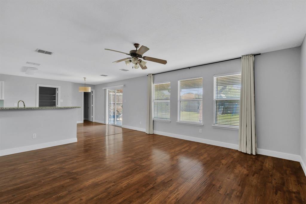 1725 Willow Way Anna, TX 75409 - Photo 9 of 33 a view of an empty room with wooden floor and a window