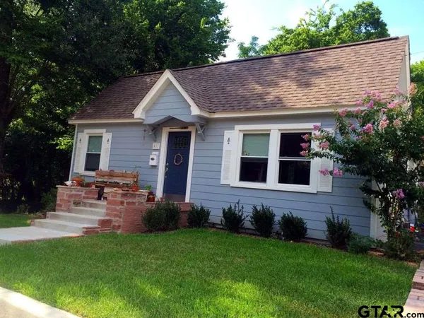 a view of house with a yard