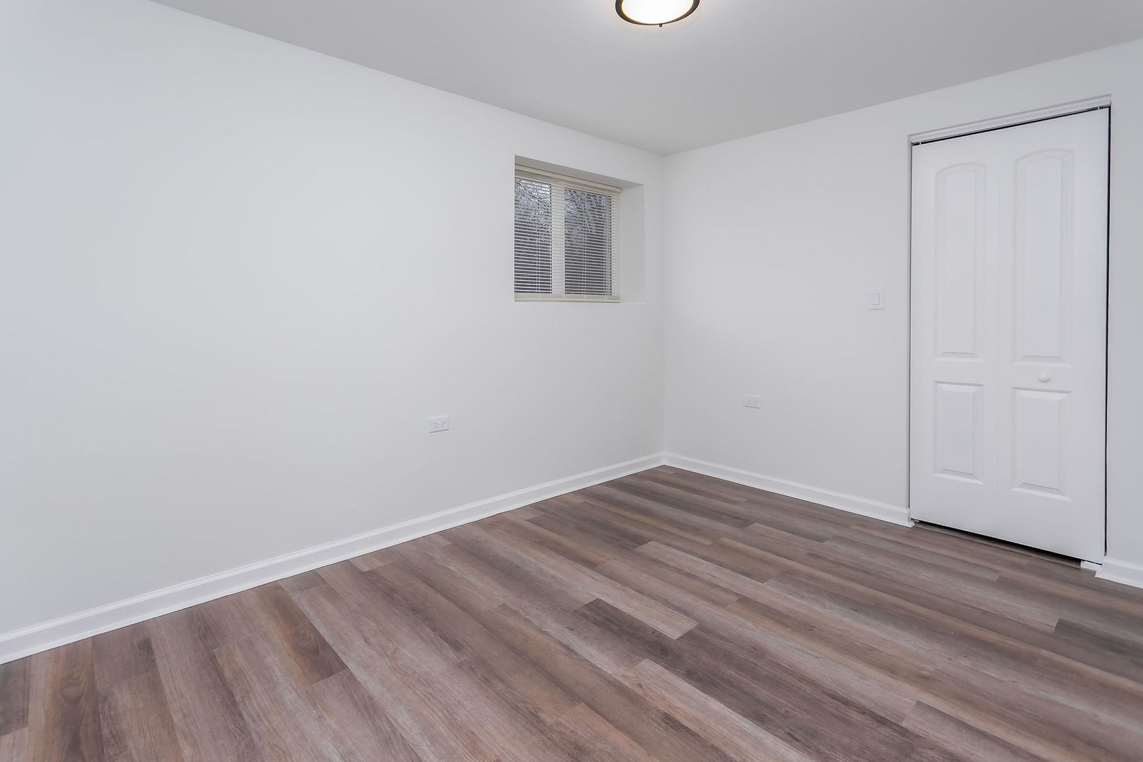 15331 Cherry Lane Markham, IL 60428 - Photo 12 of 13 a view of an empty room with wooden floor and a window