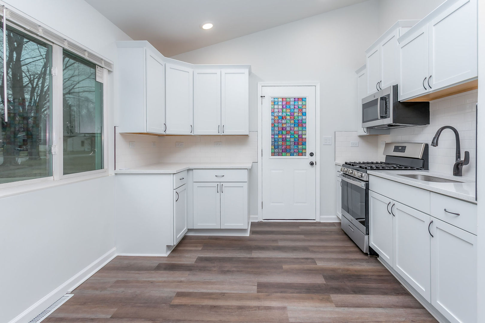 15331 Cherry Lane Markham, IL 60428 - Photo 4 of 13 a kitchen with granite countertop a sink cabinets stainless steel appliances and a window