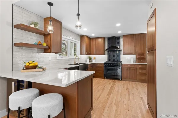 a kitchen with kitchen island a large counter top space a sink stainless steel appliances and cabinets