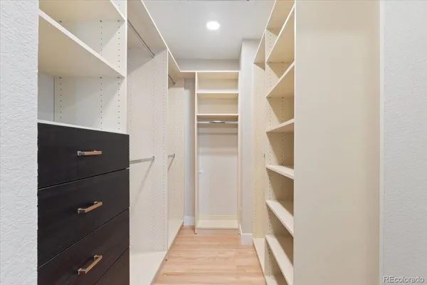 a bathroom with double vanity sinks a mirror and a bathtub