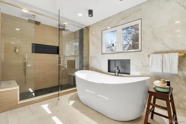 a bathroom with a granite countertop toilet sink and mirror