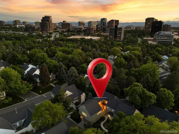 an aerial view of a tennis ground with a large trees