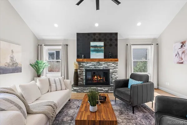 a living room with furniture and a fireplace