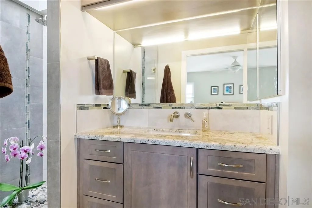 2130 Orinda Drive, Unit E Cardiff, CA 92007 - Photo 16 of 24 a bathroom with a granite countertop sink and a mirror