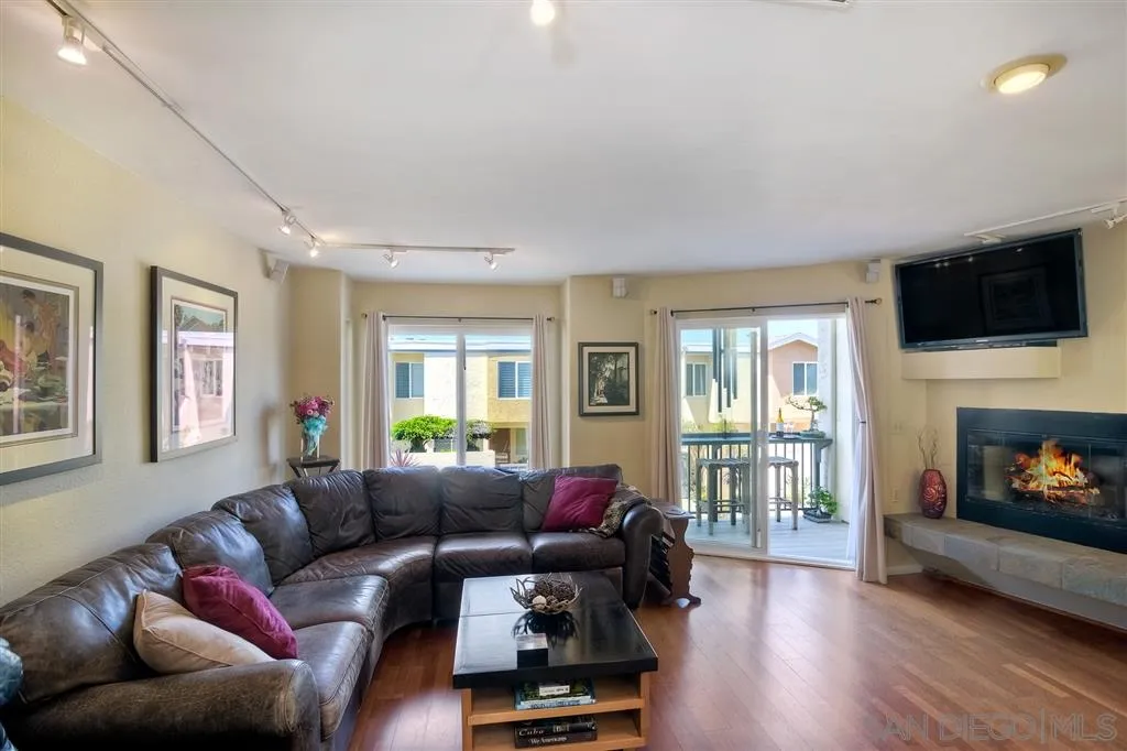 2130 Orinda Drive, Unit E Cardiff, CA 92007 - Photo 6 of 24 a living room with furniture a flat screen tv and a fireplace