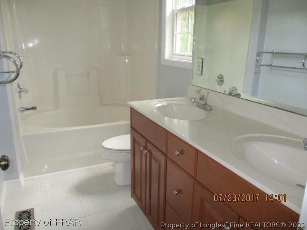 154 Chesapeake Road Cameron, NC 28326 - Photo 11 of 29 a bathroom with a granite countertop sink a toilet and shower
