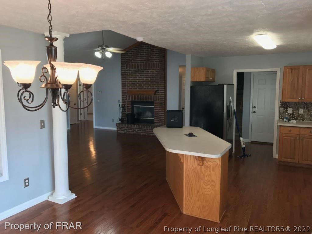154 Chesapeake Road Cameron, NC 28326 - Photo 13 of 29 a view of a kitchen with refrigerator and wooden floor