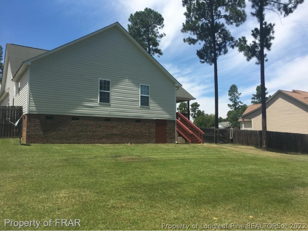 154 Chesapeake Road Cameron, NC 28326 - Photo 22 of 29 a backyard of a house with table and chairs