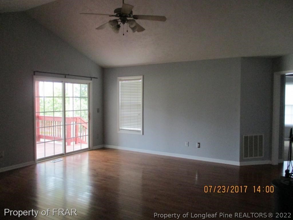154 Chesapeake Road Cameron, NC 28326 - Photo 3 of 29 an empty room with wooden floor and windows