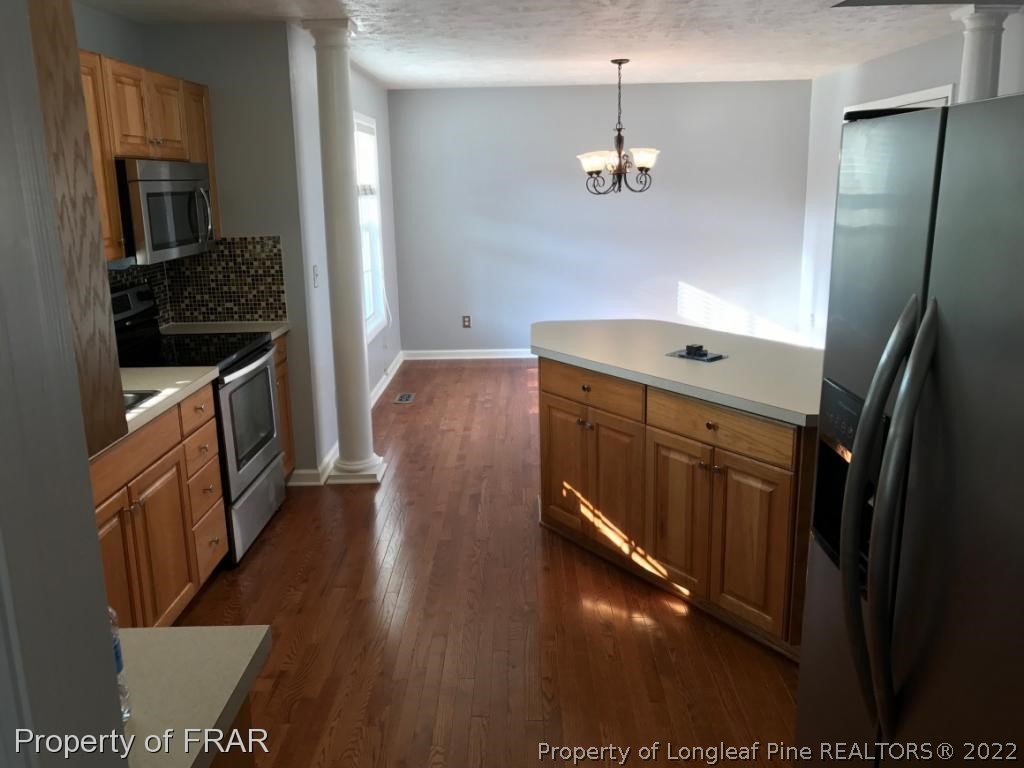 154 Chesapeake Road Cameron, NC 28326 - Photo 6 of 29 a kitchen with kitchen island granite countertop a stove and a refrigerator