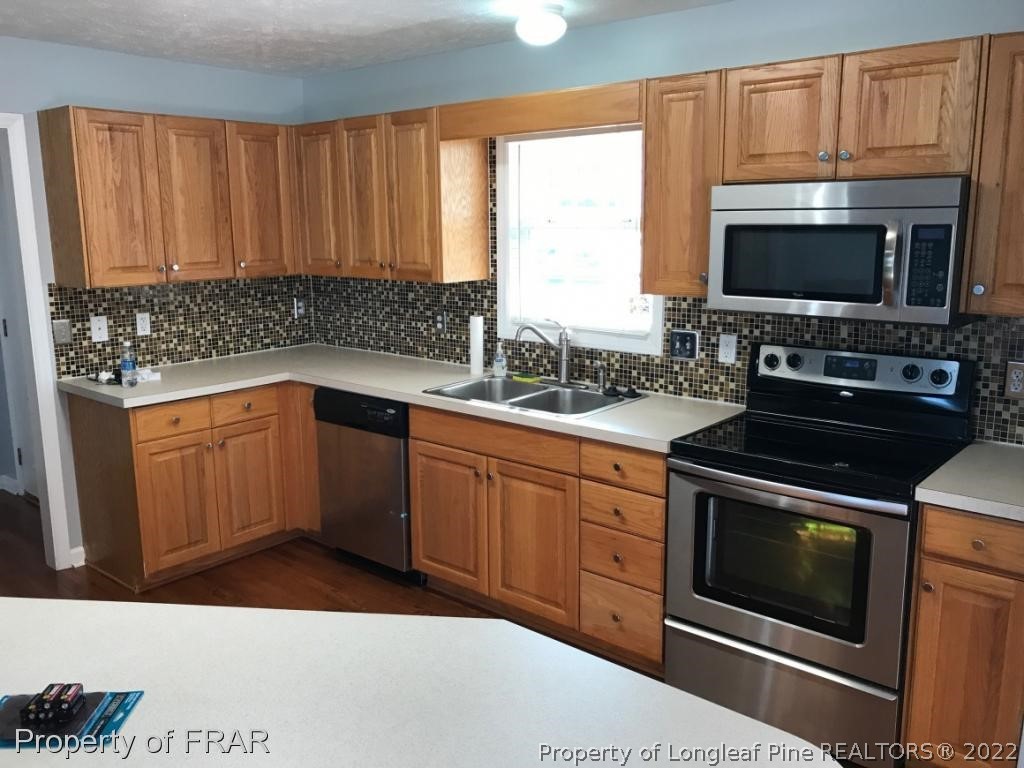 154 Chesapeake Road Cameron, NC 28326 - Photo 7 of 29 a kitchen with a sink stove and microwave