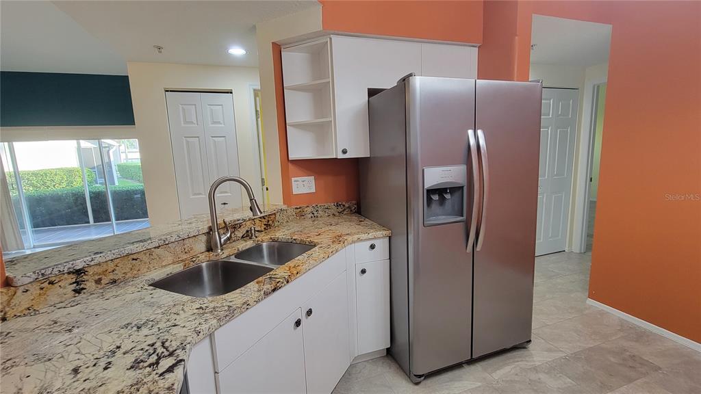 6330 Green Oak Circle, Unit 6330 Bradenton, FL 34203 - Photo 11 of 58 a kitchen with stainless steel appliances granite countertop a refrigerator and a sink